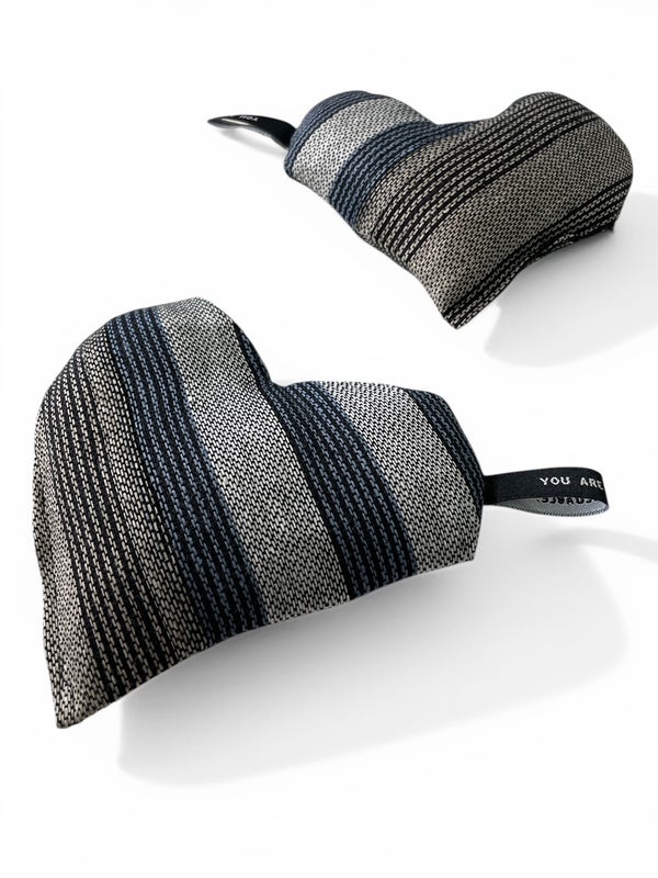 Small heart-shaped warming pillow in striped blueand black with white and beige